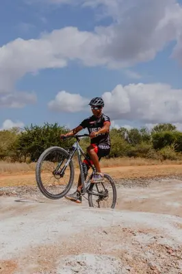 a man riding a bike on a dirt road at Cape Vulture Lodge in Hoedspruit