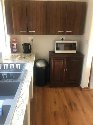 a kitchen with a counter top and a microwave at Le Bella Dons in Graskop