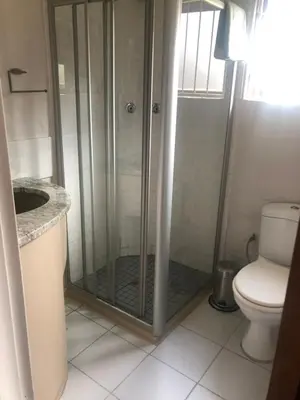 a bathroom with a shower with a toilet and a sink at Le Bella Dons in Graskop
