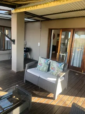 a couch sitting on a porch with a patio at Le Bella Dons in Graskop