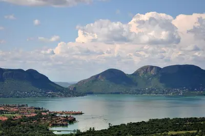 a view of a large body of water with mountains at Rock House at Benlize in Hartbeespoort