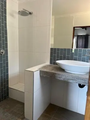 a bathroom with a sink and a shower at Rock House at Benlize in Hartbeespoort