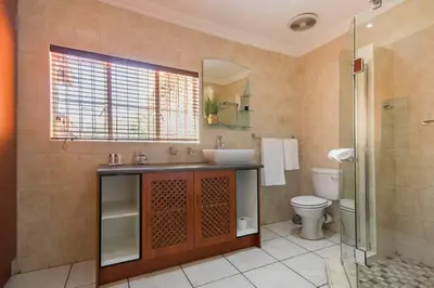 a bathroom with a sink and a toilet at Beautiful and Modern apartment close to Menlyn in Pretoria
