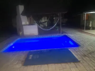 a blue swimming pool at night with at 15 On Reitz Bela bela in Bela-Bela