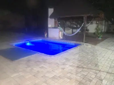 a swimming pool in a backyard at night at 15 On Reitz Bela bela in Bela-Bela