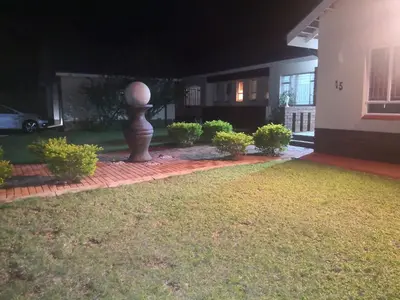 a yard with a statue in front of a house at 15 On Reitz Bela bela in Bela-Bela