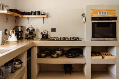 a kitchen with a counter with pots and pans at Ostrich Hide in Marloth Park