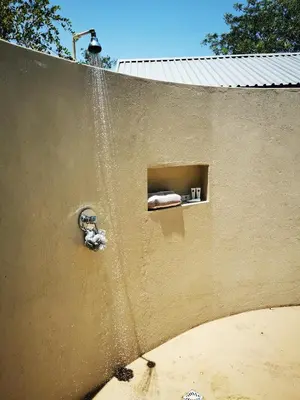 a wall with a water fountain on it at Ostrich Hide in Marloth Park