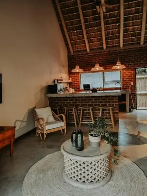 a living room with a table in the middle of a room at UmnDeni Africa in Hoedspruit