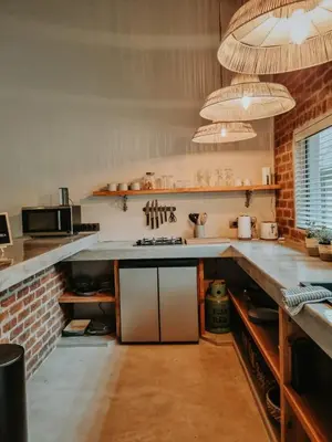a kitchen with a counter top and a brick wall at UmnDeni Africa in Hoedspruit