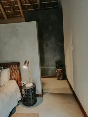a bedroom with a bed and a black chalkboard at UmnDeni Africa in Hoedspruit