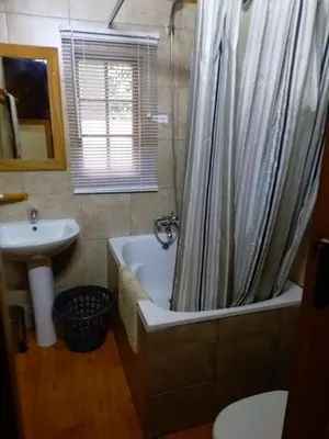 a bathroom with a bath tub and a sink at Crocodile Nest B&B in Nelspruit