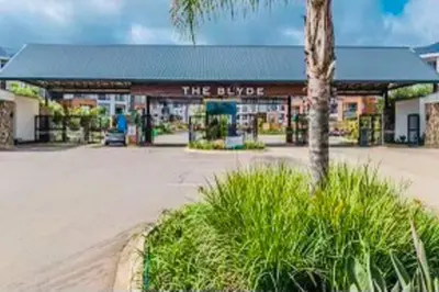 a store front of a building with a palm tree at The Blyde -Ender137 in Pretoria