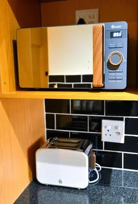 a toaster sitting on top of a counter with a mirror at Unit 508 at Menlyn Place in Pretoria