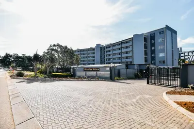 a parking lot in front of a large building at Unit 508 at Menlyn Place in Pretoria