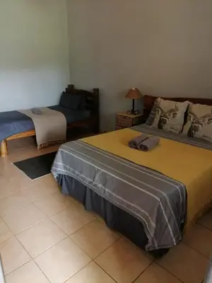 a bedroom with two beds and a couch in a room at Ebenhaeser overnight accomodation in Bela-Bela