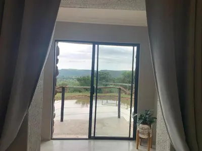 a room with a door to a balcony with a view at Hazyview Accommodation, Bon Repose Cottage 1 in Hazyview