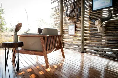 a bath tub sitting in a room with a laptop at Sunbirds Oasis Lodge in Hoedspruit