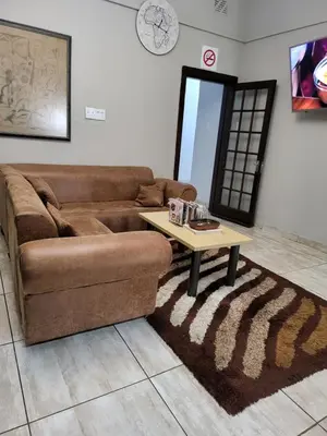 a living room with a couch and a coffee table at G On M Guest House in Pretoria