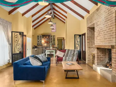 a living room with a blue couch and a fireplace at 295 on Ingwenya in Dullstroom