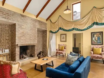 a living room with a blue couch and a fireplace at 295 on Ingwenya in Dullstroom