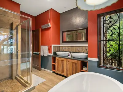 a bathroom with two sinks and red walls at 295 on Ingwenya in Dullstroom