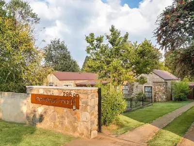 a sign on a stone wall in front of a house at 295 on Ingwenya in Dullstroom