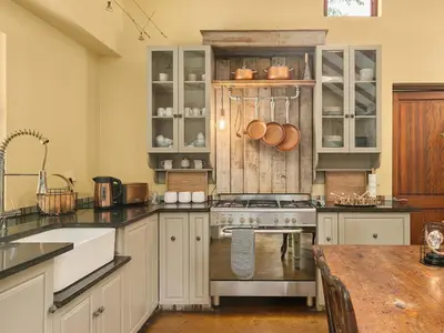a kitchen with white cabinets and a stove top oven at 295 on Ingwenya in Dullstroom