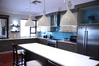 a large kitchen with a large white counter top at The Sanctum in Hartbeespoort