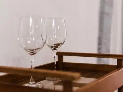 three wine glasses sitting on a tray on a table at Cussonia Cottage in Haenertsburg