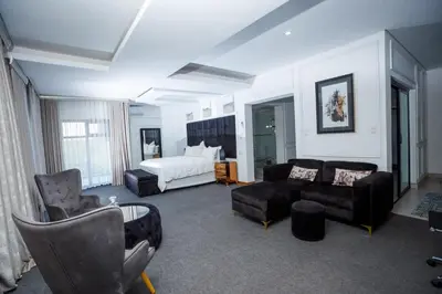 a living room with a bed and a couch at Nandoni Waterfront Resort in Thohoyandou