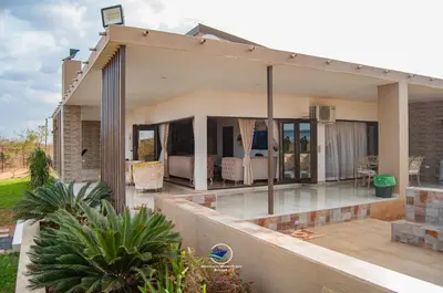 a house with a balcony with a bedroom at Nandoni Waterfront Resort in Thohoyandou