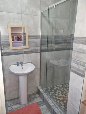 a bathroom with a sink and a shower at Ribeng la Noka Conference and Leisure Center in Ga-Ramokadi-kadi