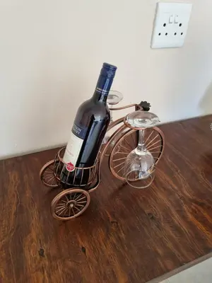 a bottle of wine in a bike holder on a table at Ribeng la Noka Conference and Leisure Center in Ga-Ramokadi-kadi