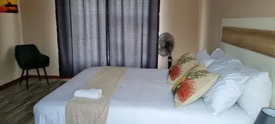 a bedroom with a bed with white sheets and pillows at Ribeng la Noka Conference and Leisure Center in Ga-Ramokadi-kadi