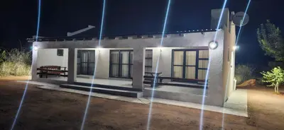 a small house at night with lights at Ribeng la Noka Conference and Leisure Center in Ga-Ramokadi-kadi