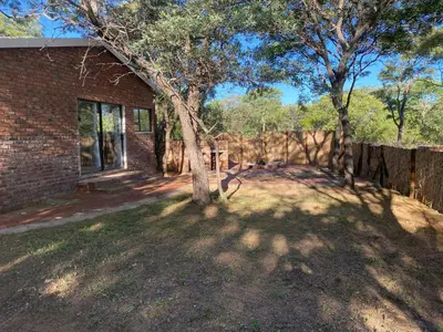 a brick house with a tree in the yard at Vlakkieskraal Farmstay - BushBaby House in Bela-Bela