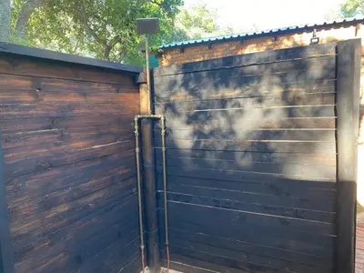 a wooden fence with a gate and a street light at Vlakkieskraal Farmstay - BushBaby House in Bela-Bela