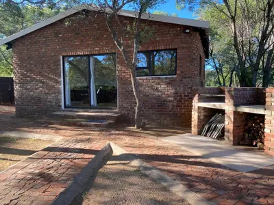 a brick building with a large window on the side at Vlakkieskraal Farmstay - BushBaby House in Bela-Bela