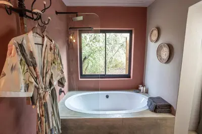 a large tub in a bathroom with a window at Muunga Bush Lodge & Spa in Hoedspruit