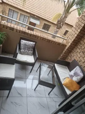an outdoor patio with chairs and a table at Home away from home in Centurion