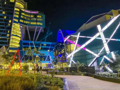 a building with lights on it at night at Menlyn Maine Residences - Superior king - Paris apartment in Pretoria