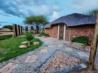 a garden in front of a brick building at Unique Overnight Polokwane in Polokwane