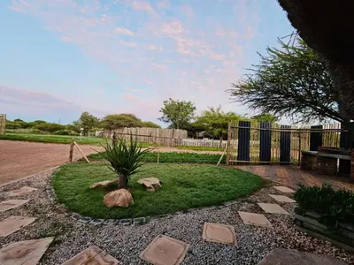 a garden with a tree in the middle of a yard at Unique Overnight Polokwane in Polokwane