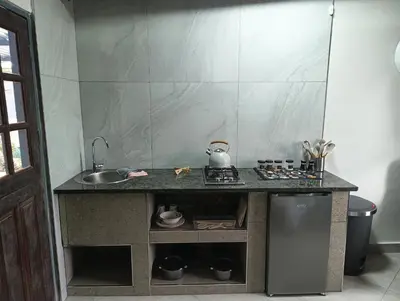 a kitchen with a counter with a sink and a stove at Unique Overnight Polokwane in Polokwane