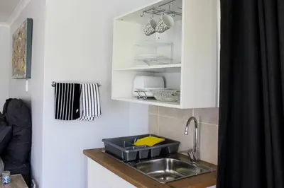 a kitchen counter with a sink and a cabinet at 4 on Verbena in Boksburg