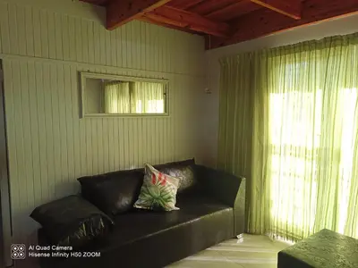 a black leather couch in a room with a window at 4 on Verbena in Boksburg