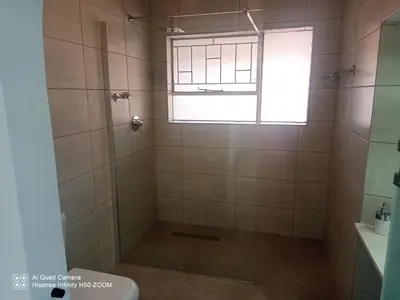 a bathroom with a shower with a window at 4 on Verbena in Boksburg