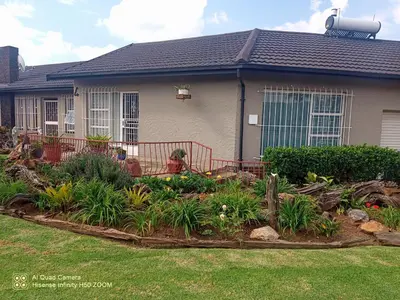a house with a garden in the front yard at 4 on Verbena in Boksburg