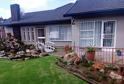 a house with a rock garden in front of it at 4 on Verbena in Boksburg